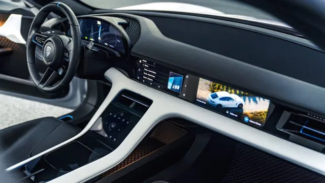 Taycan cockpit with curved driver display and passenger screen