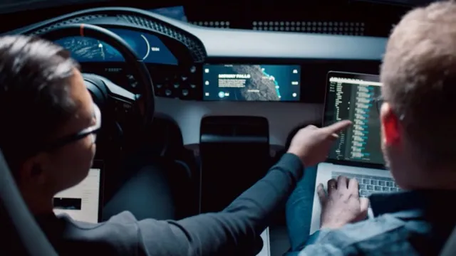 Two people prototyping the Taycan infotainment on a laptop inside the car